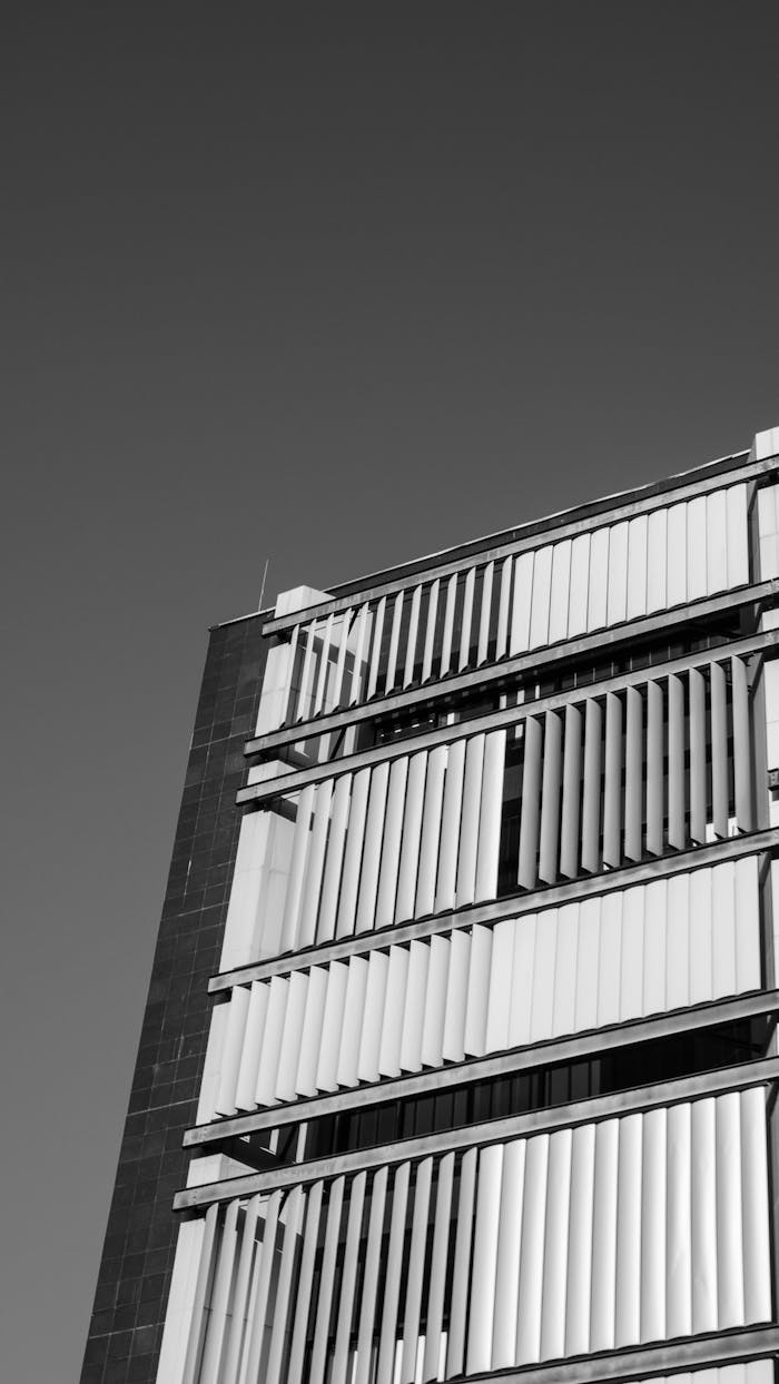 Monochrome shot of a modern building facade with vertical blinds in Curitiba, Brazil.